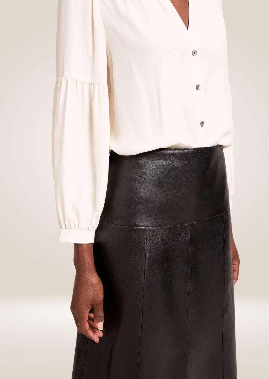 Stylish black leather midi skirt featuring smooth finish and elegant minimalist design