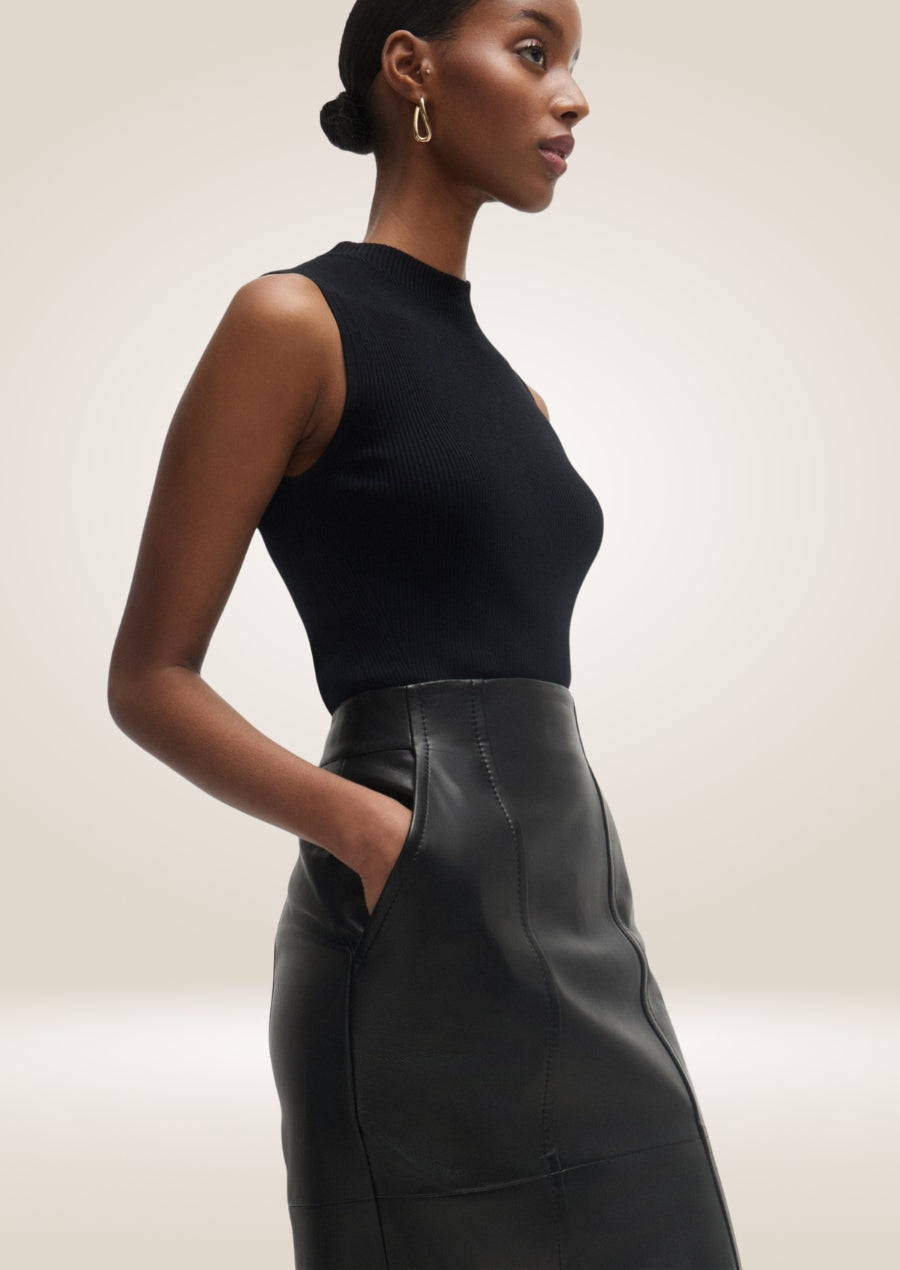 Black leather pencil skirt with high waist and sleek body-hugging tailored silhouette