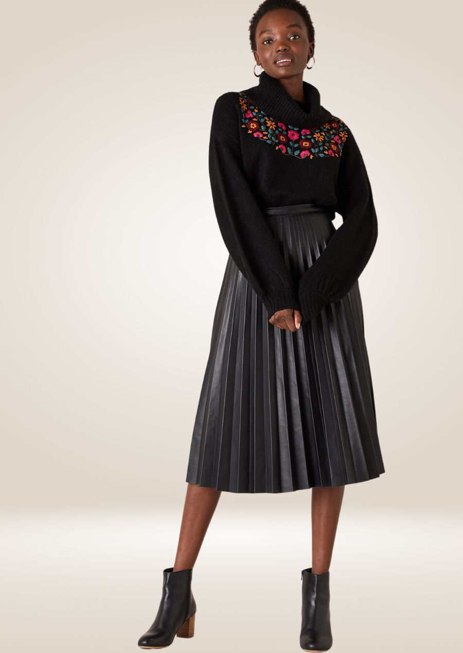 Black pleated leather midi skirt with elegant flowy design and refined structured pleats