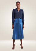 Metallic blue leather midi skirt with structured waistline and glossy reflective surface