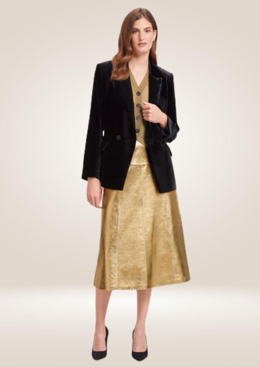 Metallic gold leather midi skirt featuring glossy texture and sleek high-waisted silhouette