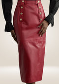 Red leather pencil skirt with military-inspired gold buttons and smooth polished finish