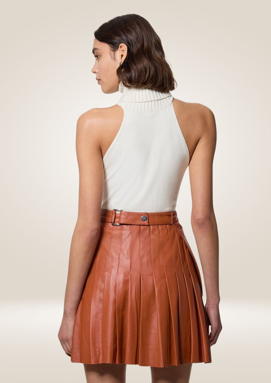 Tan leather mini skirt crafted from premium leather with structured pleats and smooth finish