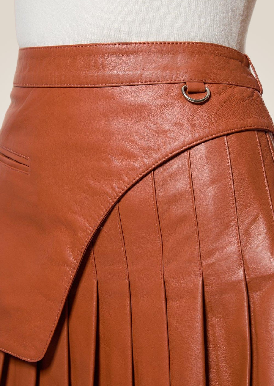Elegant tan pleated leather mini skirt offering chic versatile look for casual or formal wear