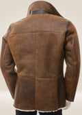 Back view of the tan sheepskin shearling pea coat, emphasizing the sleek silhouette and luxurious material.