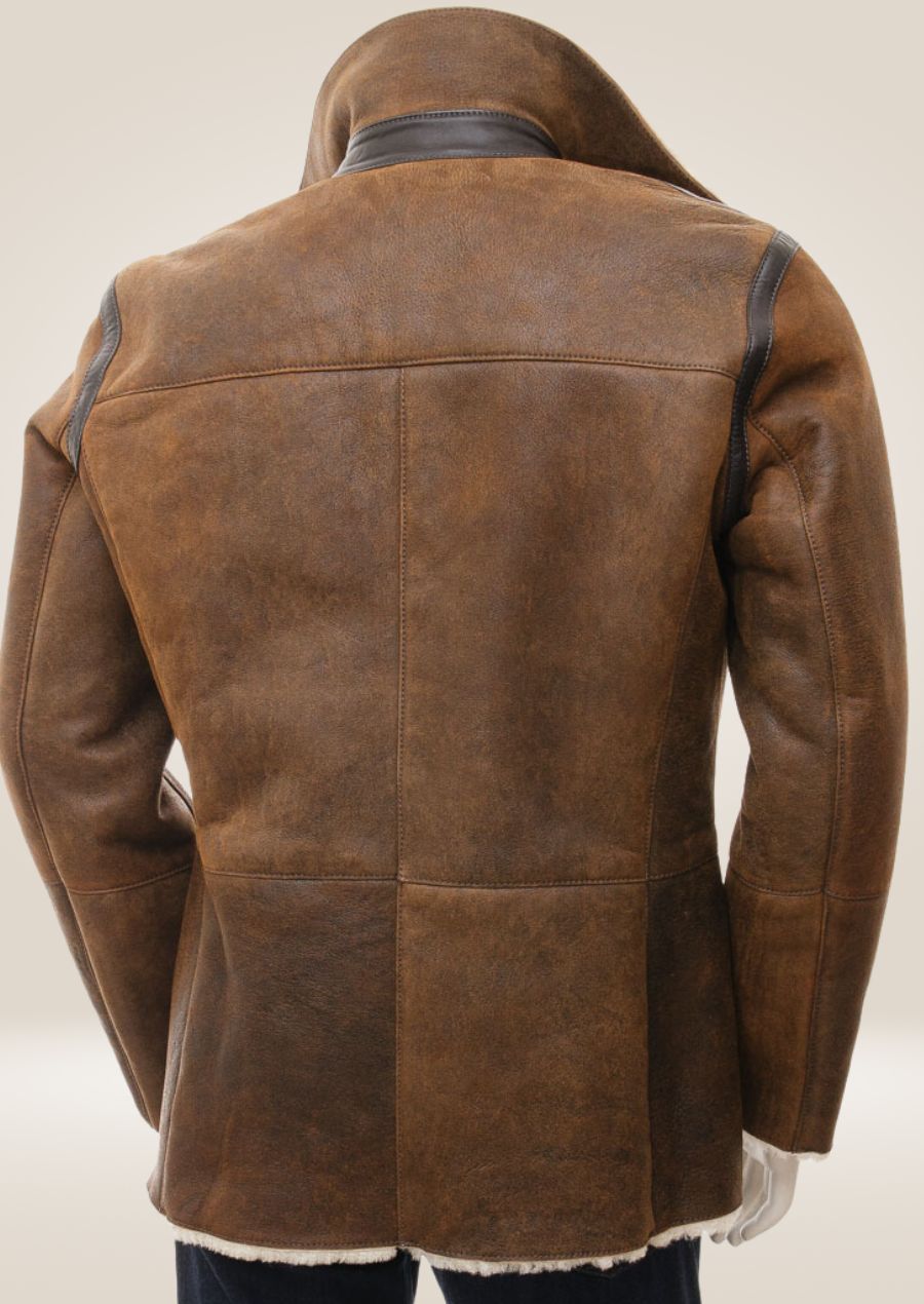 Back view of the tan sheepskin shearling pea coat, emphasizing the sleek silhouette and luxurious material.