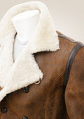 Close-up of the shoulder area of the tan sheepskin shearling pea coat, highlighting the plush texture and expert craftsmanship.