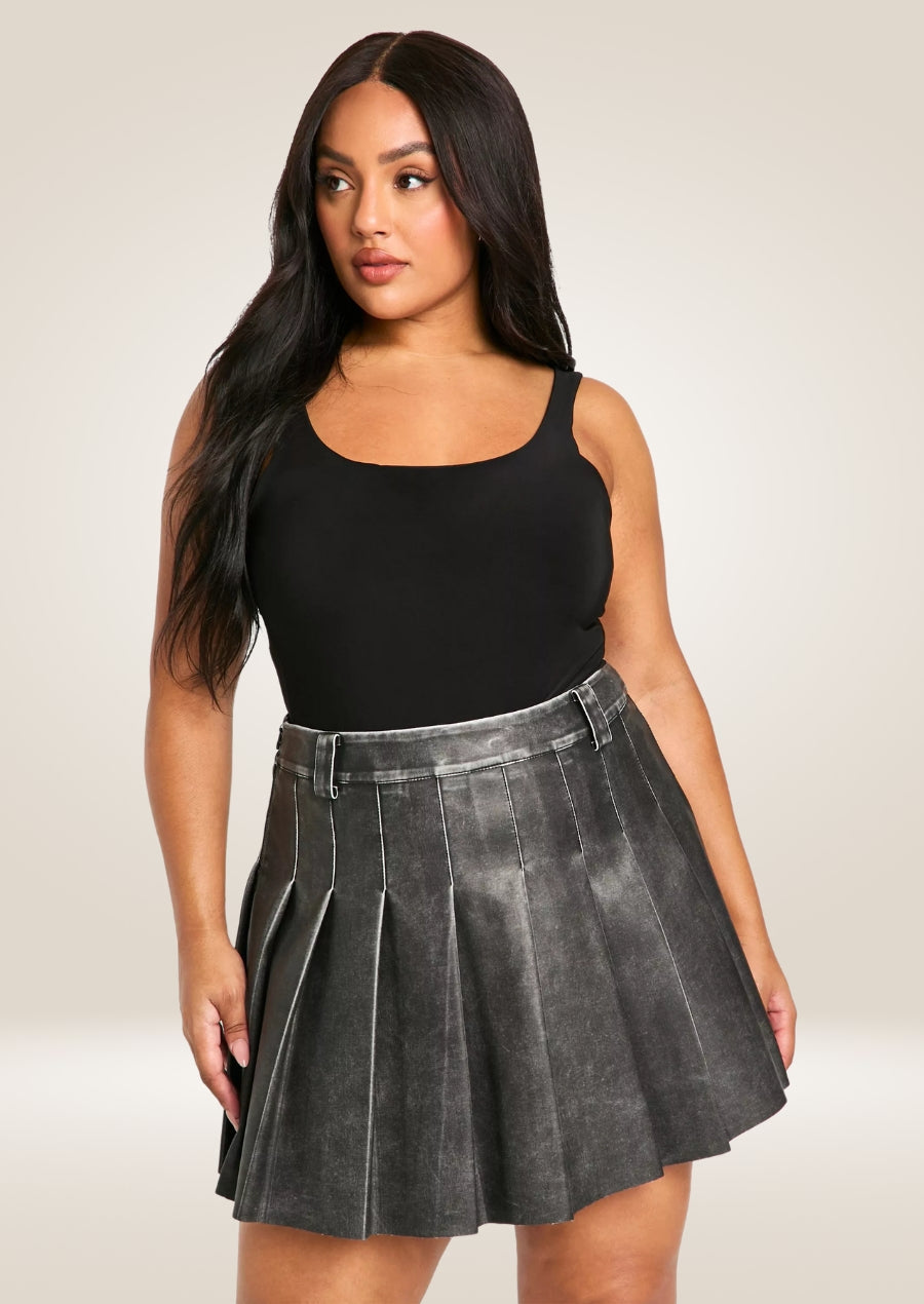 Vintage leather mini skirt featuring soft worn-in texture and classic high-waisted silhouette